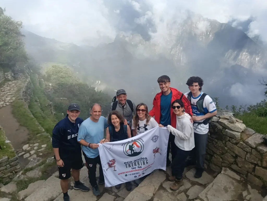 Inca Trail Machu Picchu trekkers celebrating at the Sun Gate at sunrise on day four