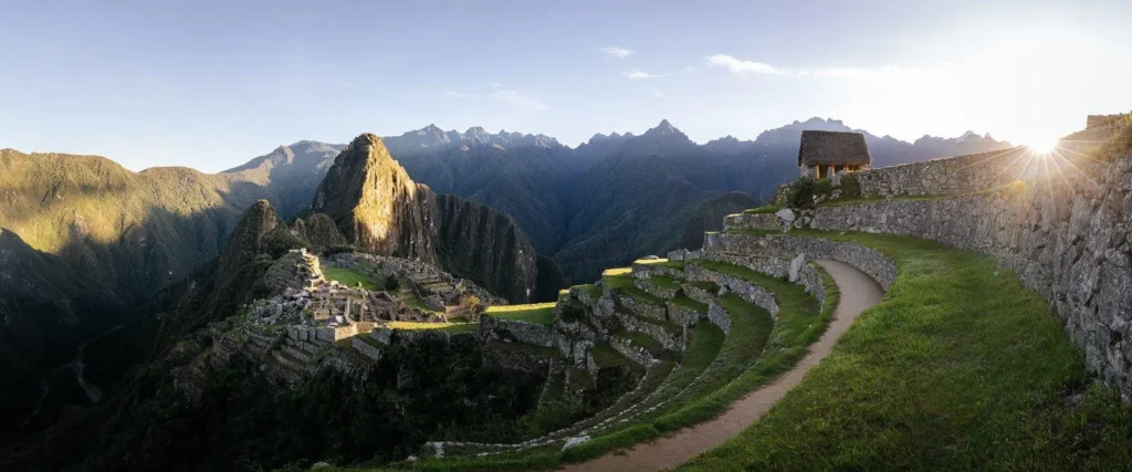 Machu Picchu tours panoramic view of the ancient Inca citadel at sunrise with mountain backdrop