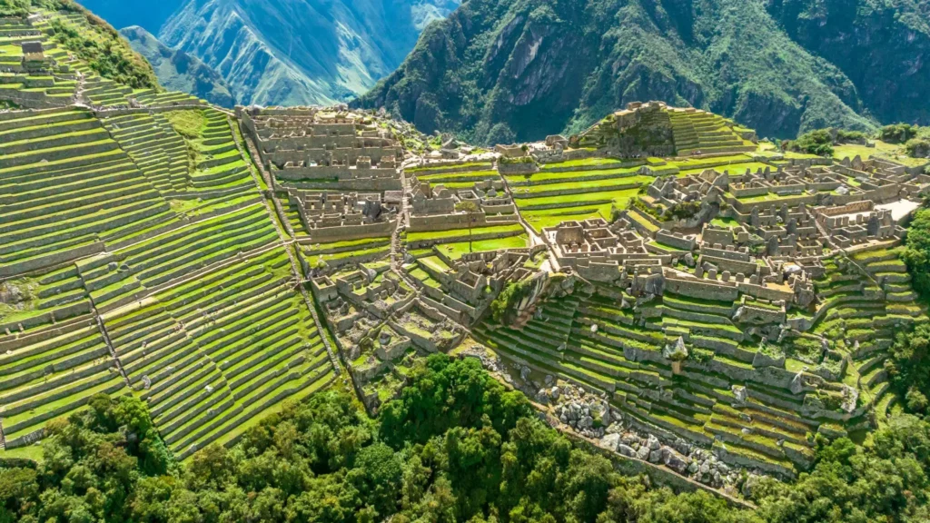 Stone agricultural terraces on a green hillside in the Peruvian Andes